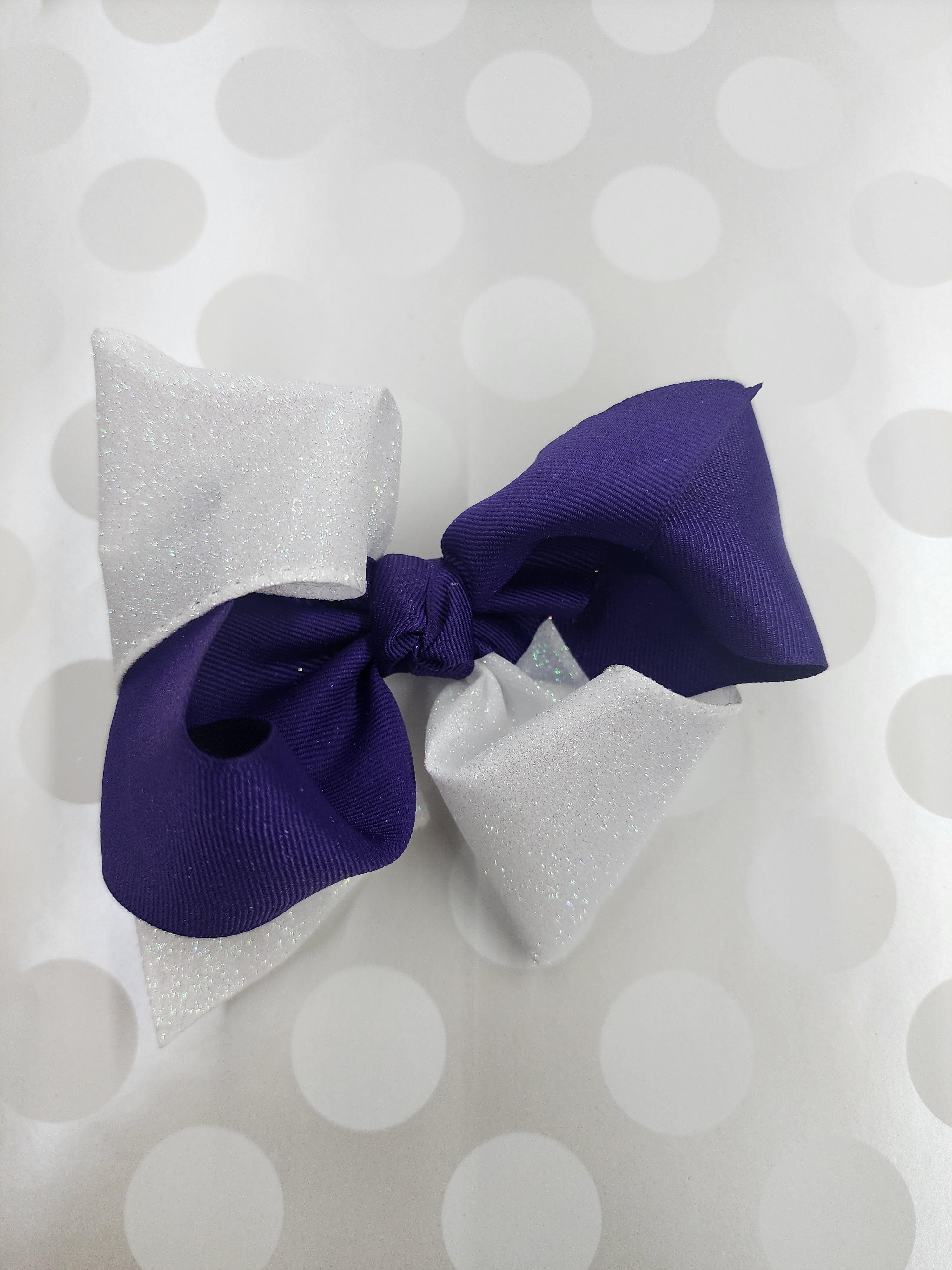 CRISS-CROSSED PURPLE AND WHITE GLITTER SCHOOL BOW
