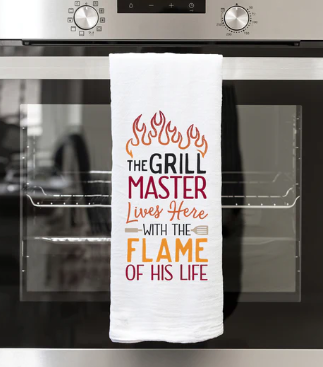 THE GRILL MASTER LIVES HERE WITH THE FLAME OF HIS LIFE TEA TOWEL